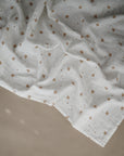 Lifestyle image of Organic Cotton Swaddle in Sparrow