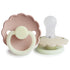 The FRIGG Daisy Night Silicone Pacifier 2-Pack by FRIGG features two pastel pink and beige pacifiers with scalloped edges, circular handles, and transparent nipples.
