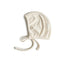 The mushie Ribbed Baby Bonnet is a soft, cream-colored organic cotton bonnet with a ribbed texture, rounded shape, and two ties at the bottom, shown on a white background.