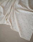 Lifestyle image of Organic Cotton Swaddle in Cherries