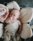 Lifestyle image of a baby swaddled in organic cotton swaddle in Fog