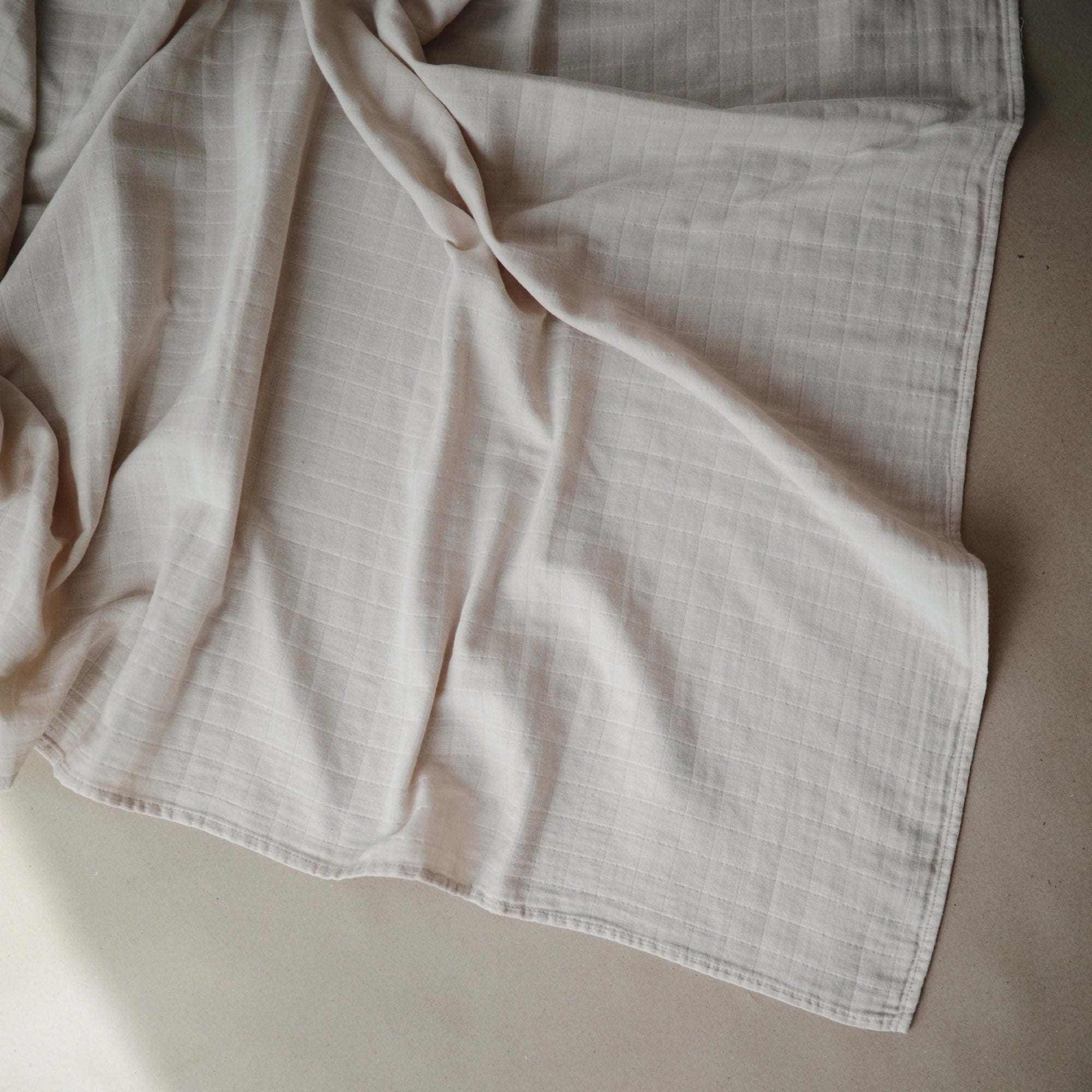 Lifestyle image of Organic Cotton Swaddle in Fog