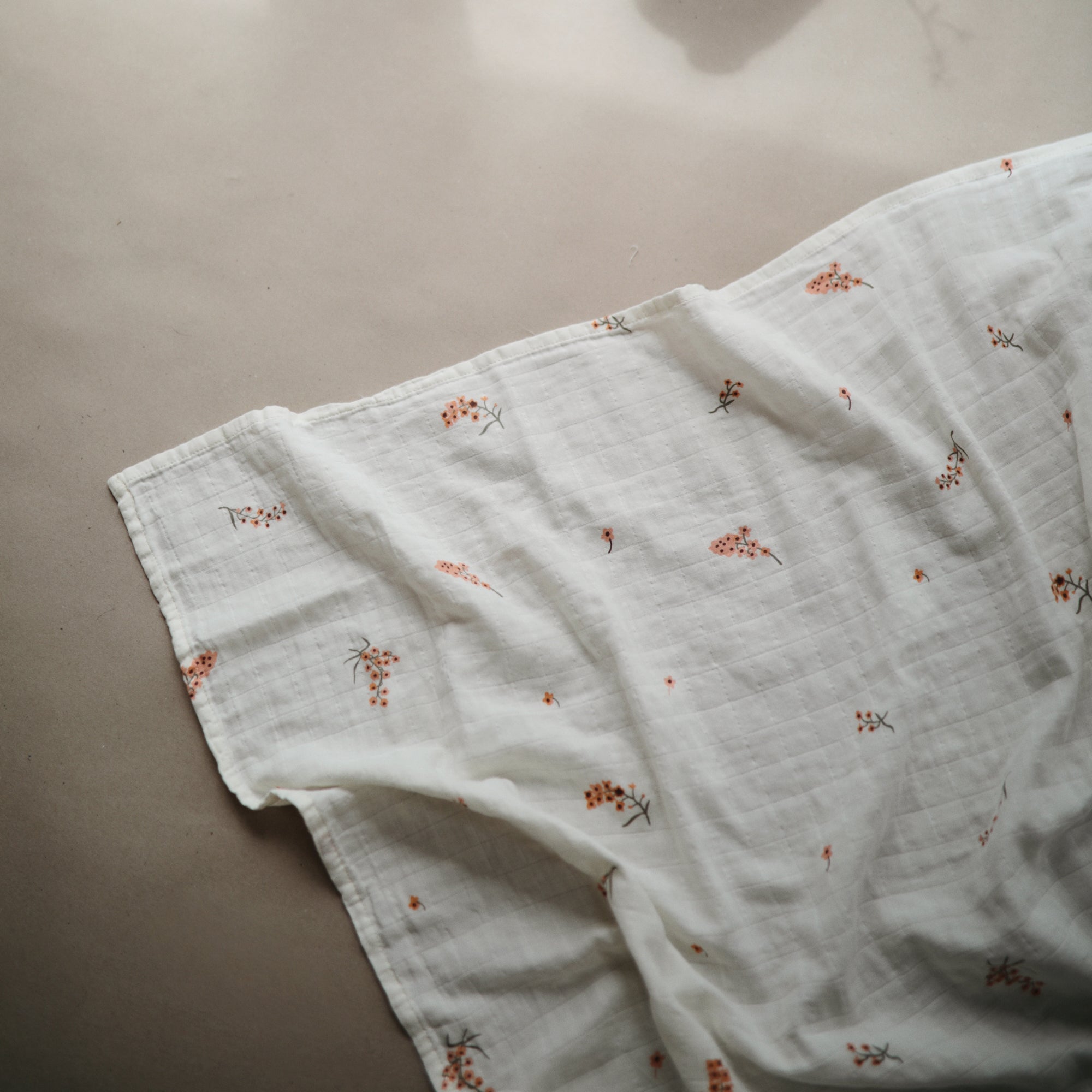 Lifestyle image of Organic Cotton Swaddle in Flowers