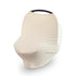 The mushie Multi-Use Cover in cream stretches over a car seat with a black handle, featuring smooth gathered fabric at the bottom; this versatile cover also functions as a convenient nursing cover.