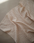 Lifestyle image of Organic Cotton Swaddle in Natural Stripe