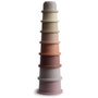 The mushie Stacking Cups Toy features eight pastel cups in a gradient, nesting from largest to smallest—a charming baby toy inspired by Danish Hygge design, shown upright on a white background.