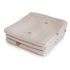 The mushie Organic Cotton Muslin Cloths 3-Pack features soft beige cloths with brown rainbow patterns, ideal for diaper bags and everyday nursery use.
