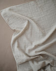 Lifestyle image of Organic Cotton Swaddle in Sage Stripe