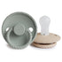 The FRIGG Rope Silicone Pacifier 2-Pack by FRIGG is shown in pale green and beige, featuring a rope-textured rim. One pacifier stands upright while the other lies down—stylish and practical essentials for your baby’s daily comfort.