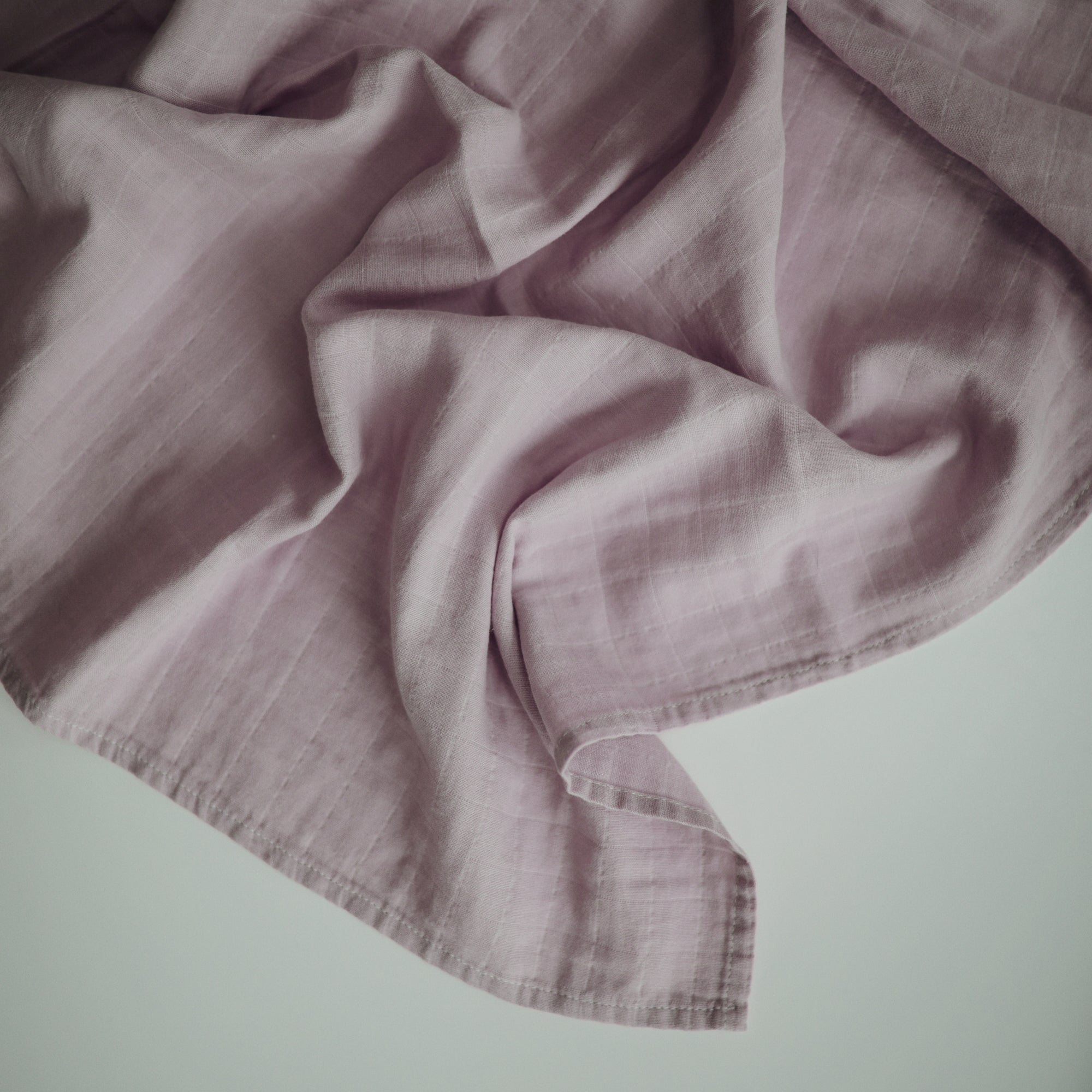 Lifestyle image of Organic Cotton Swaddle in Soft Lilac