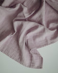 Lifestyle image of Organic Cotton Swaddle in Soft Lilac