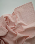 Lifestyle image of Organic Cotton Swaddle in Rose Vanilla