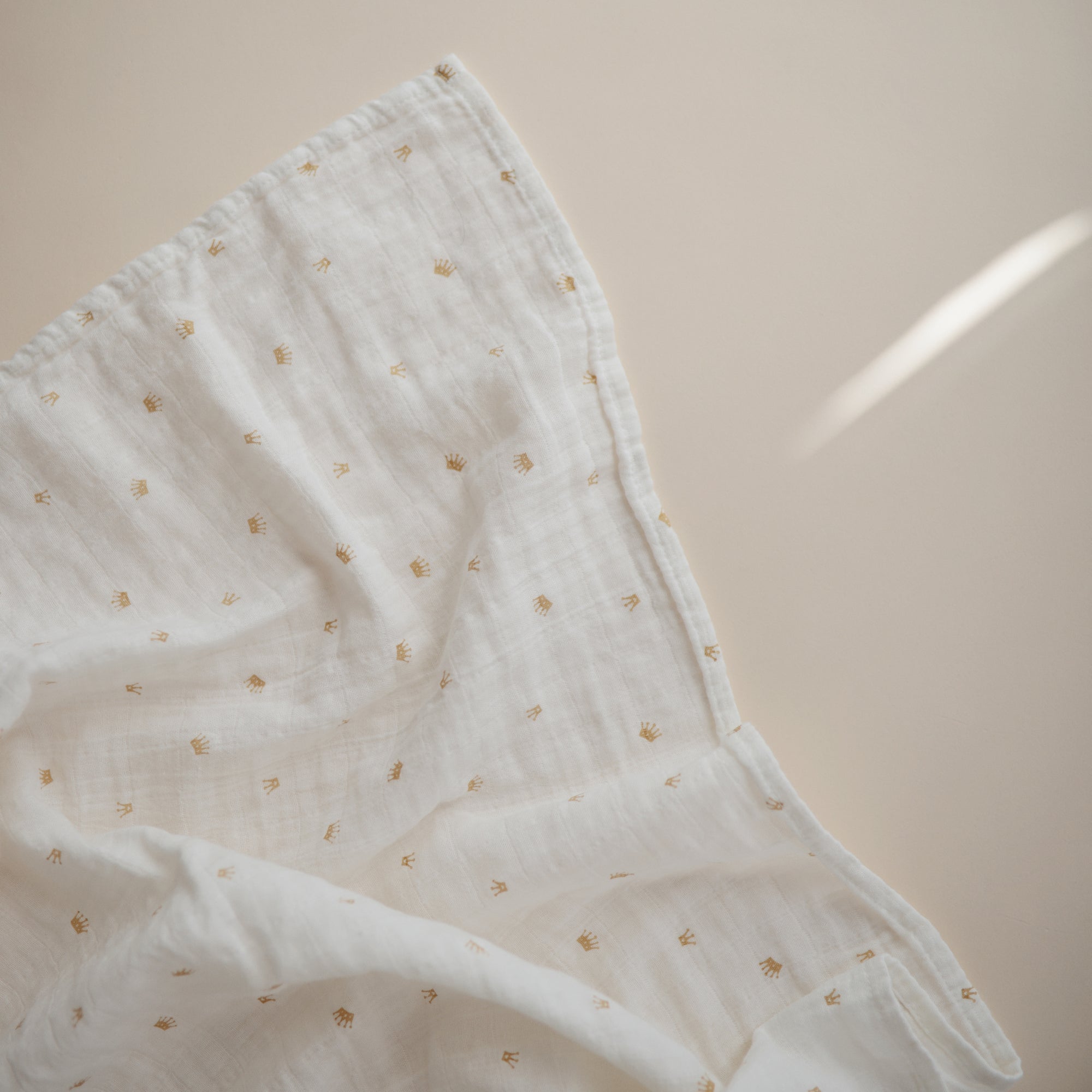 Lifestyle image of Organic Cotton Swaddle in Crowns