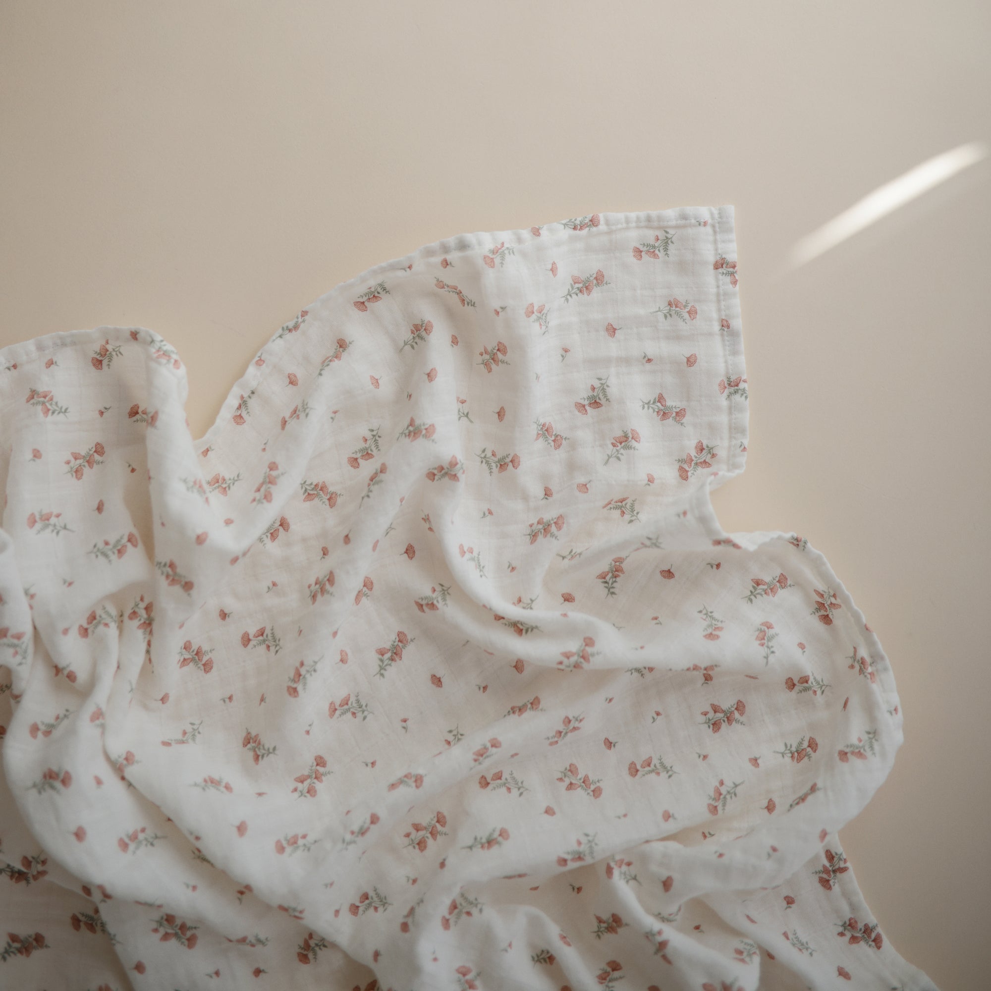 Lifestyle image of Organic Cotton Swaddle in Pink Flowers