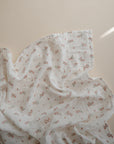 Lifestyle image of Organic Cotton Swaddle in Pink Flowers