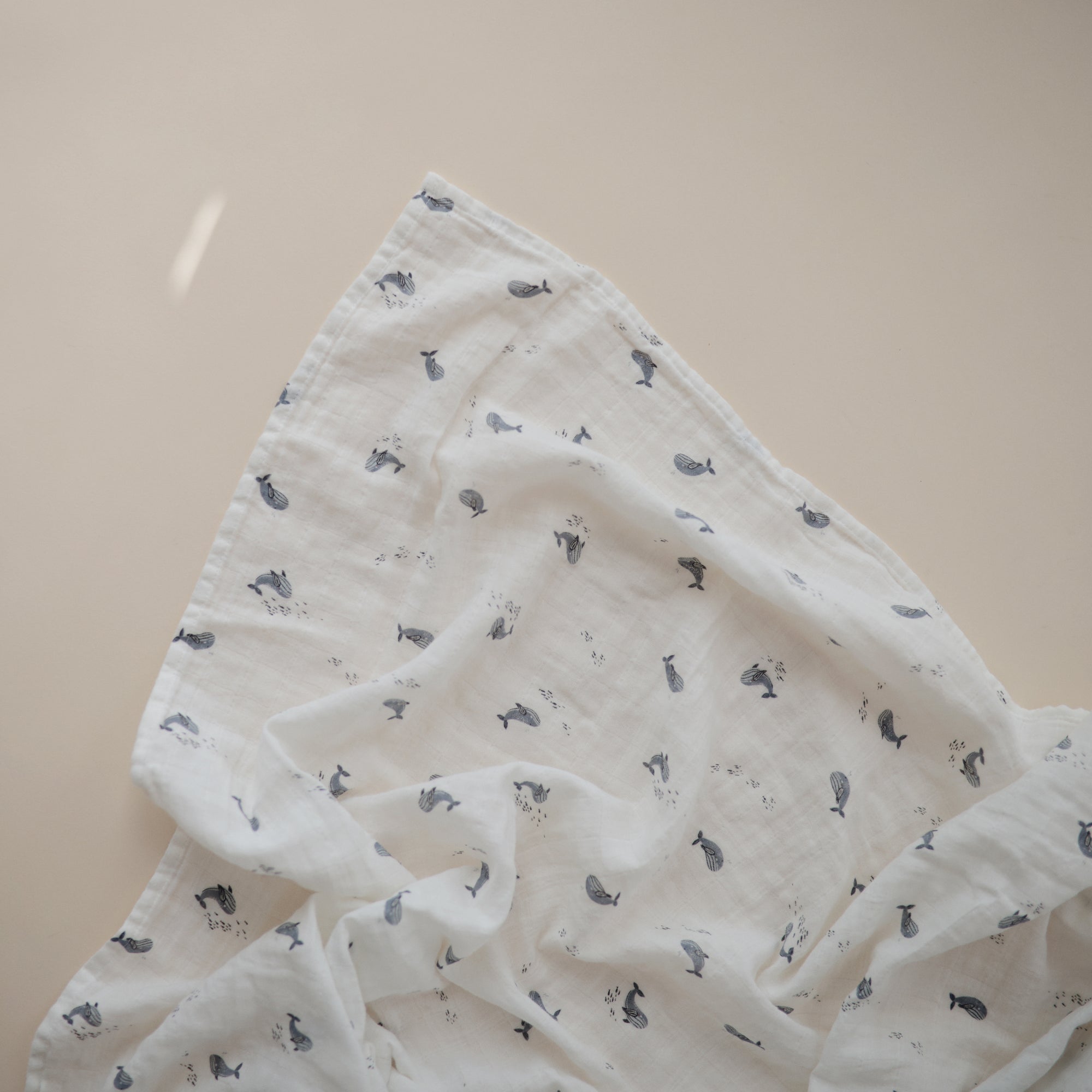 Lifestyle image of Organic Cotton Swaddle in Whales